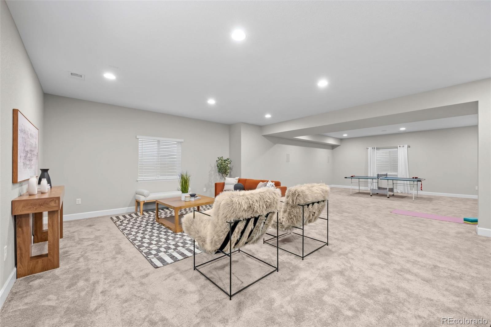 450 Pikes View Drive Erie, CO 80516 - Photo 35 of 45 a living room with furniture and a table