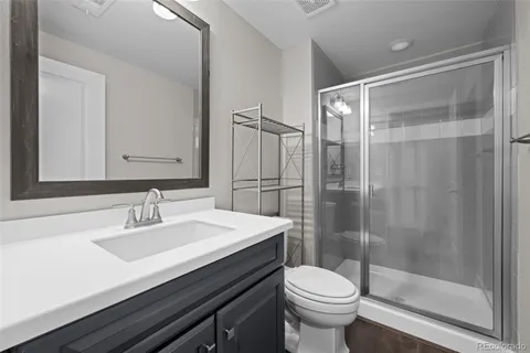 a bathroom with a sink toilet and shower