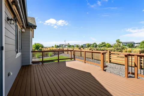 a view of a balcony with wooden floor and iron stairs