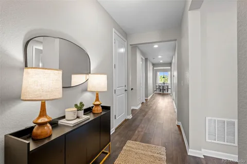 a view of a hallway to a livingroom and a couch