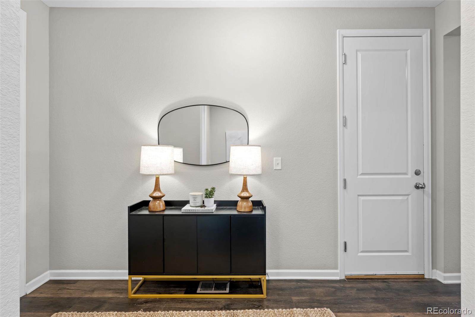 450 Pikes View Drive Erie, CO 80516 - Photo 6 of 45 a living room with a table and a mirror