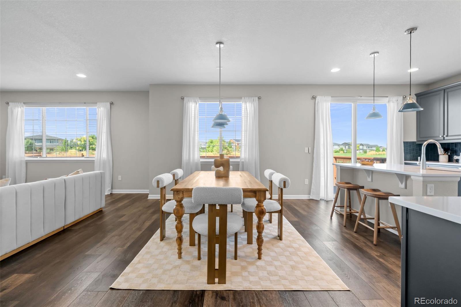 450 Pikes View Drive Erie, CO 80516 - Photo 9 of 45 a view of a dining room with furniture window and wooden floor