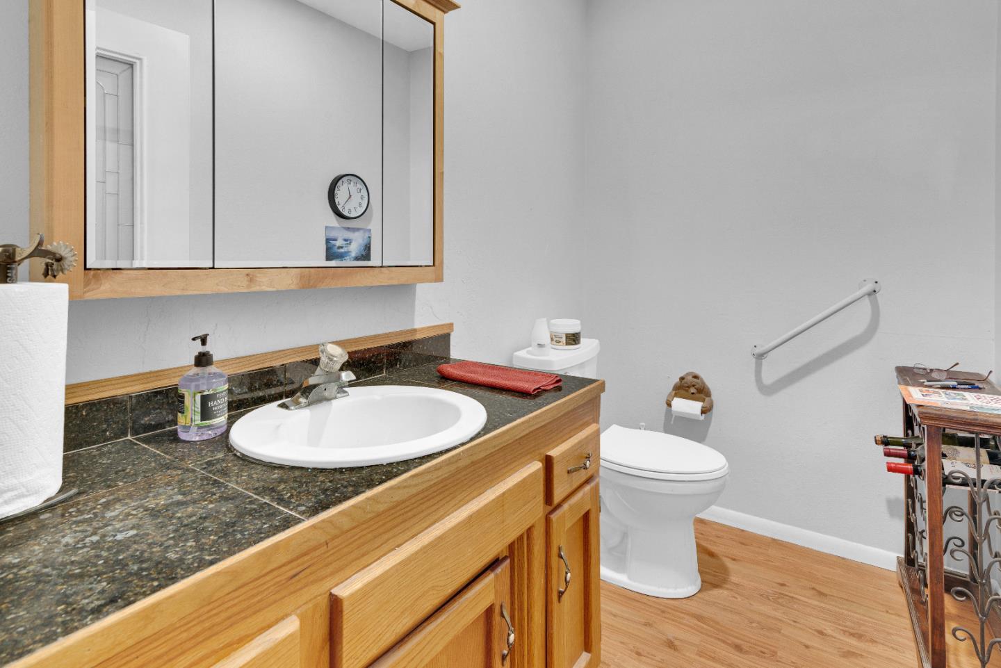 38483 Milpitas Road Greenfield, CA 93927 - Photo 28 of 55 a bathroom with a sink vanity mirror and toilet