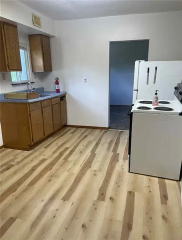 a kitchen with stainless steel appliances a sink and a refrigerator