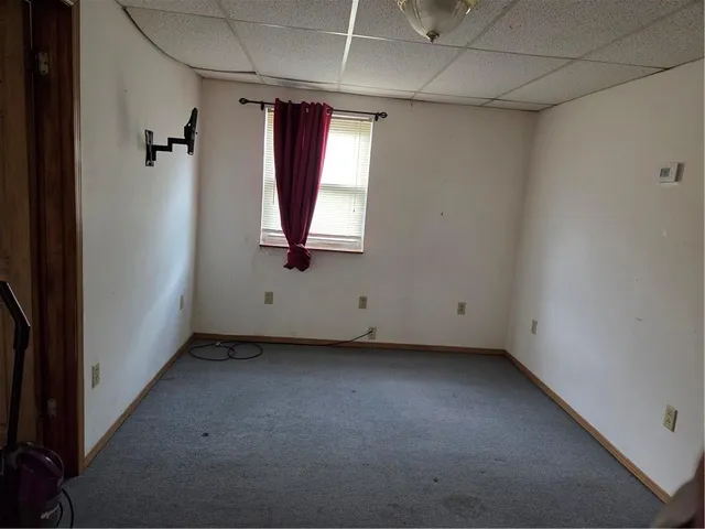a kitchen with granite countertop a sink window and cabinets