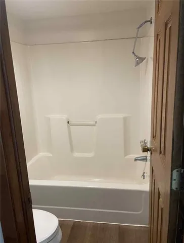 an empty room with closet and a window