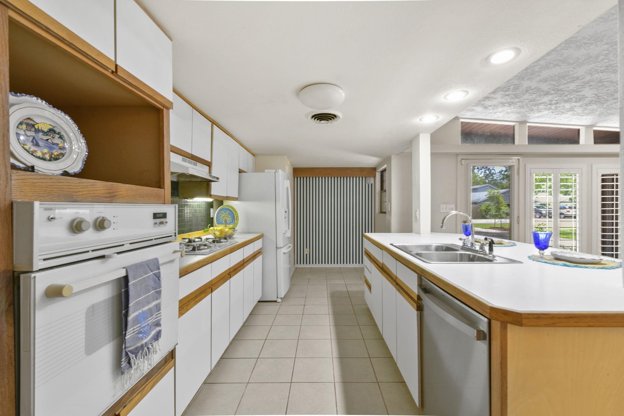 1202 Fay Road Kemah, TX 77565 - Photo 14 of 32 a kitchen with stainless steel appliances a sink a stove and a refrigerator