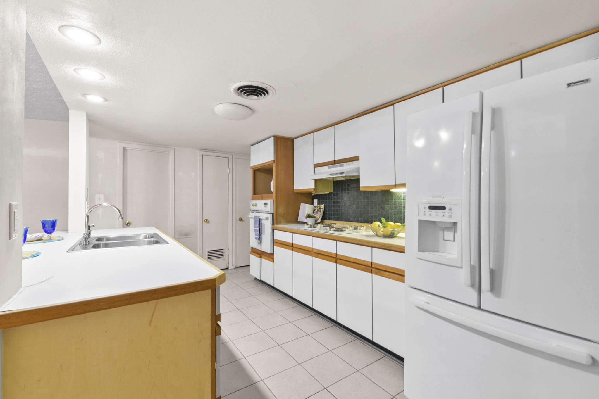 1202 Fay Road Kemah, TX 77565 - Photo 10 of 32 a large white kitchen with cabinets and stainless steel appliances