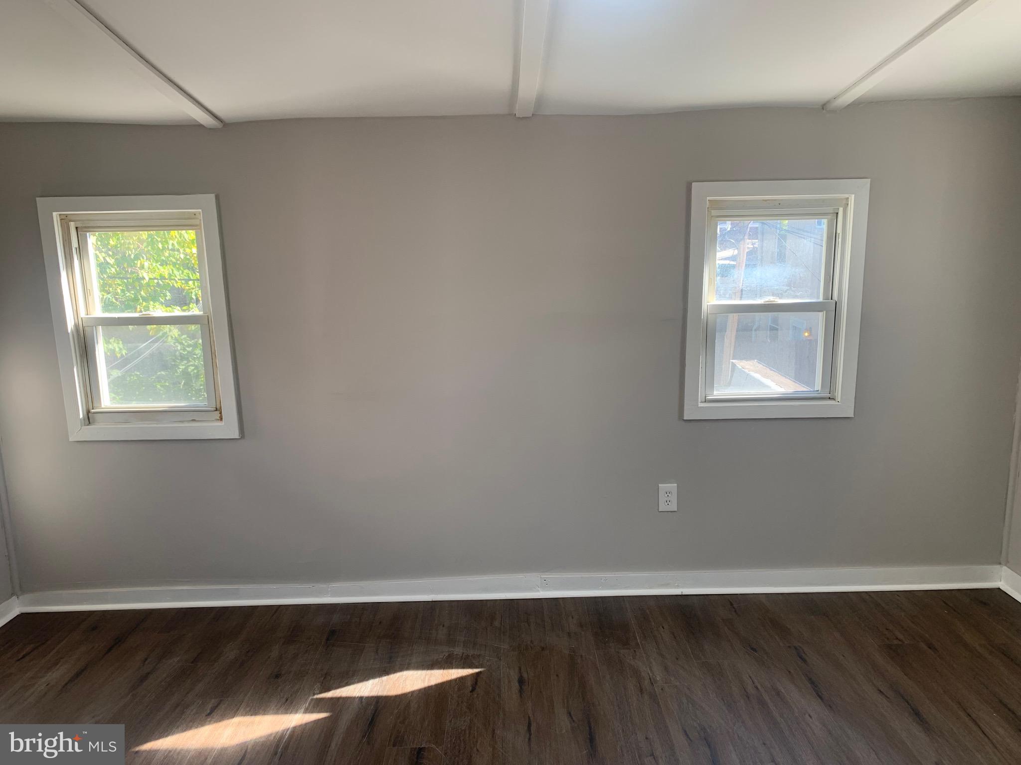2387 Orthodox Street Philadelphia, PA 19137 - Photo 12 of 12 a view of an empty room with wooden floor and a window
