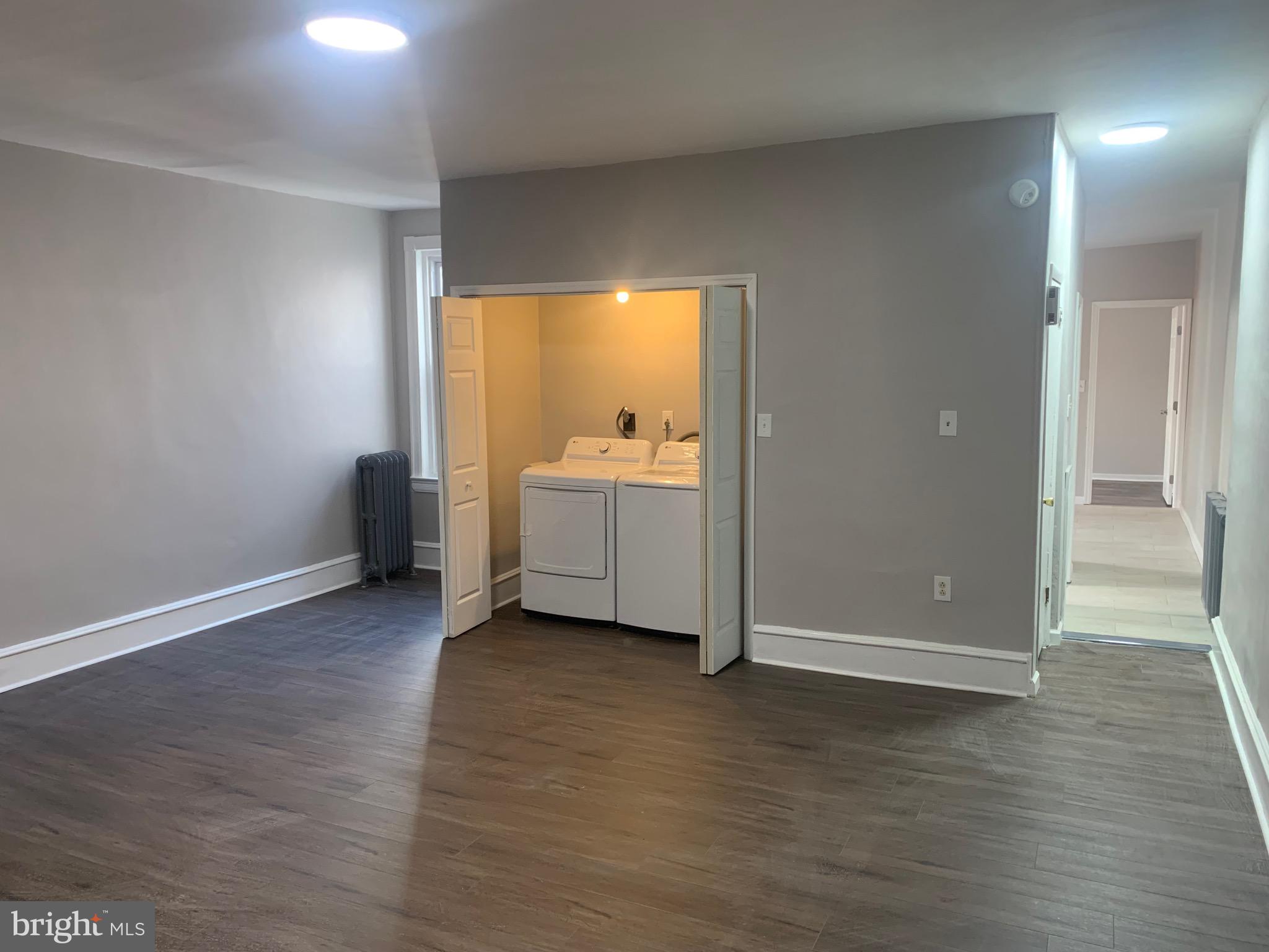 2387 Orthodox Street Philadelphia, PA 19137 - Photo 3 of 12 an empty room with wooden floor and windows