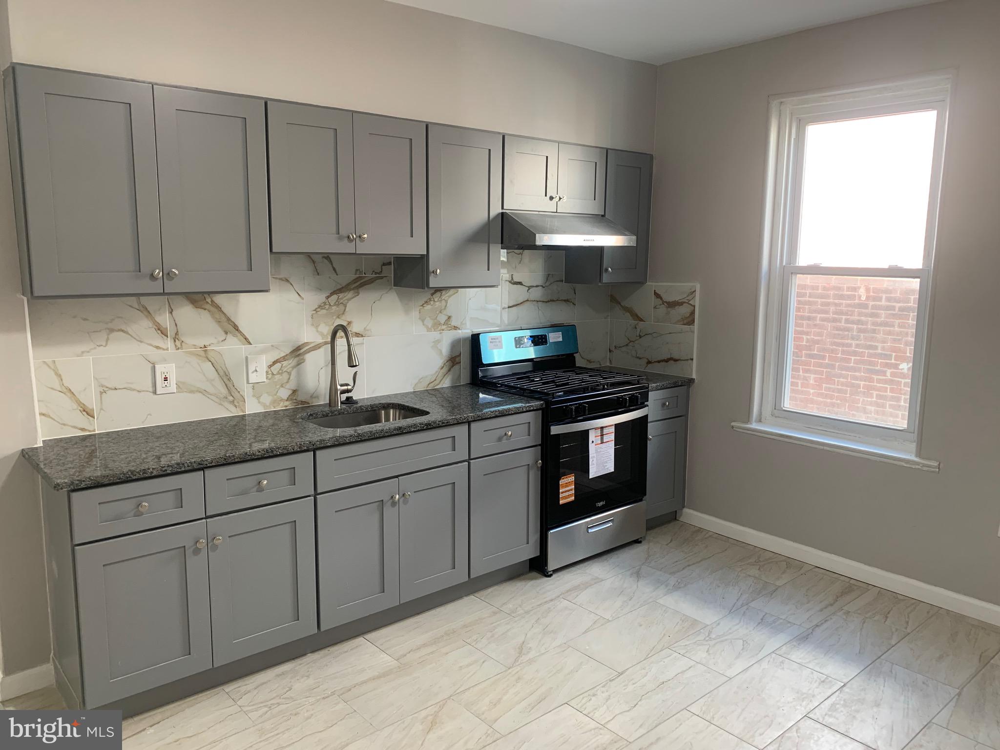 2387 Orthodox Street Philadelphia, PA 19137 - Photo 9 of 12 a kitchen with stainless steel appliances granite countertop a sink stove and cabinets