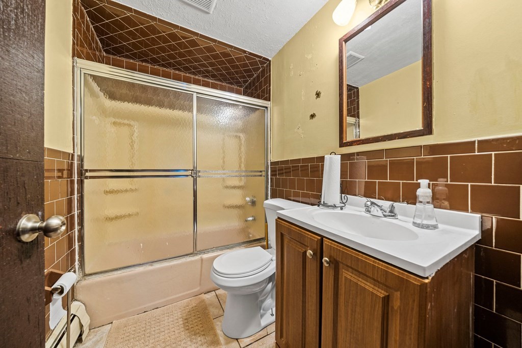 65 Wyvern Street Boston, MA 02131 - Photo 12 of 26 a bathroom with a sink toilet and shower