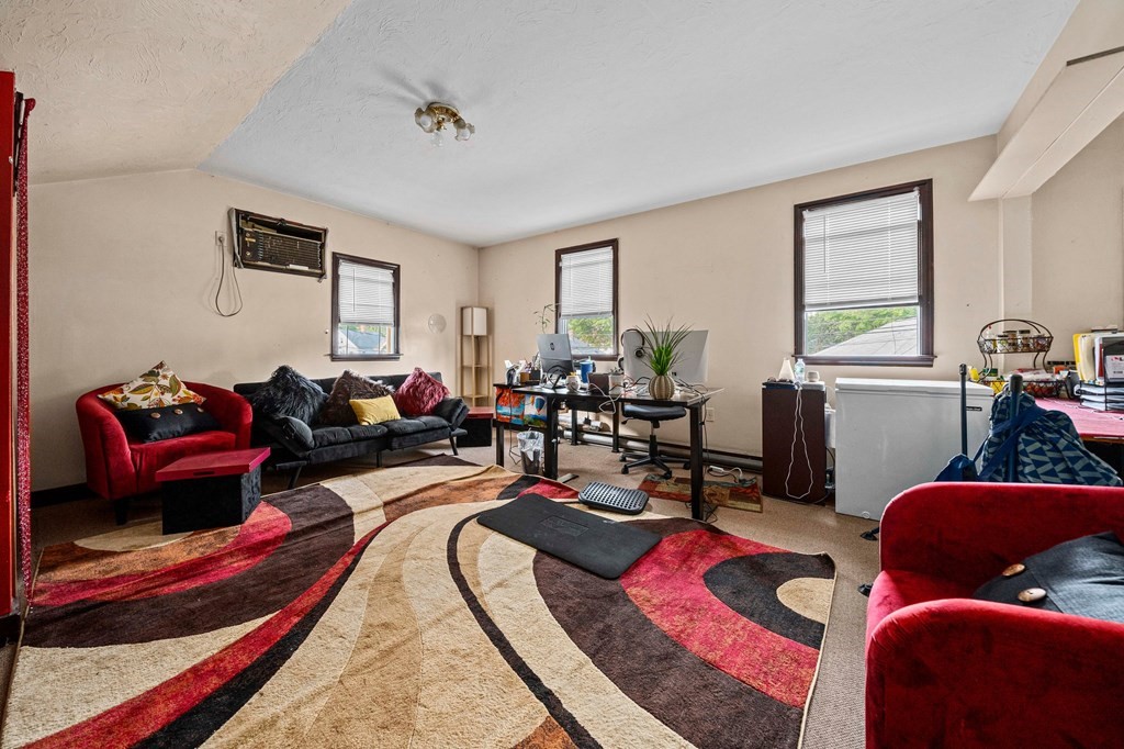 65 Wyvern Street Boston, MA 02131 - Photo 13 of 26 a living room with furniture a rug and a window