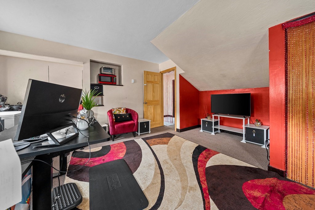 65 Wyvern Street Boston, MA 02131 - Photo 14 of 26 a living room with furniture and a flat screen tv