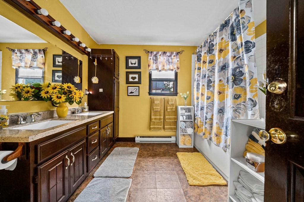 65 Wyvern Street Boston, MA 02131 - Photo 17 of 26 a bathroom with a sink mirror and shower