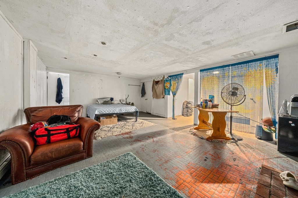 65 Wyvern Street Boston, MA 02131 - Photo 18 of 26 a living room with furniture a window and gym equipment