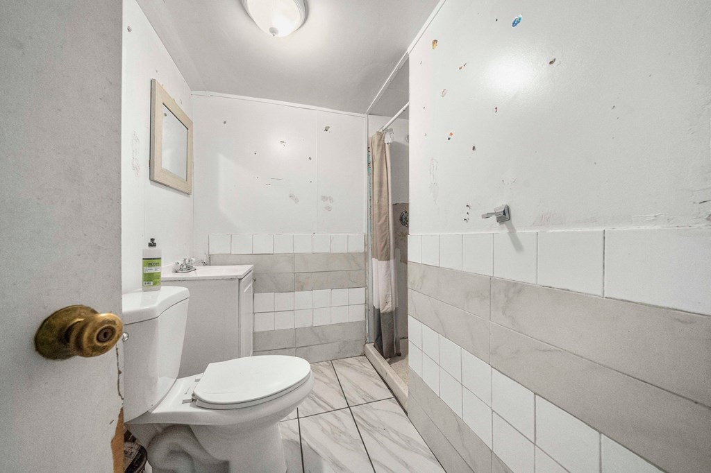 65 Wyvern Street Boston, MA 02131 - Photo 19 of 26 a bathroom with a toilet and a shower