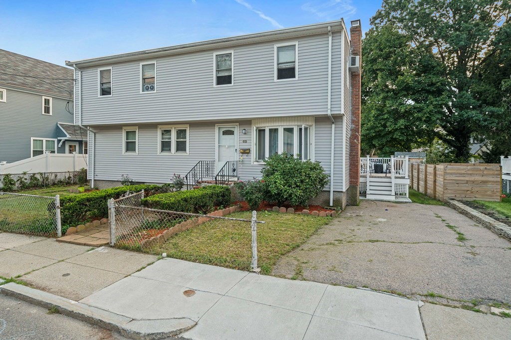 65 Wyvern Street Boston, MA 02131 - Photo 2 of 26 a front view of a house with a garden