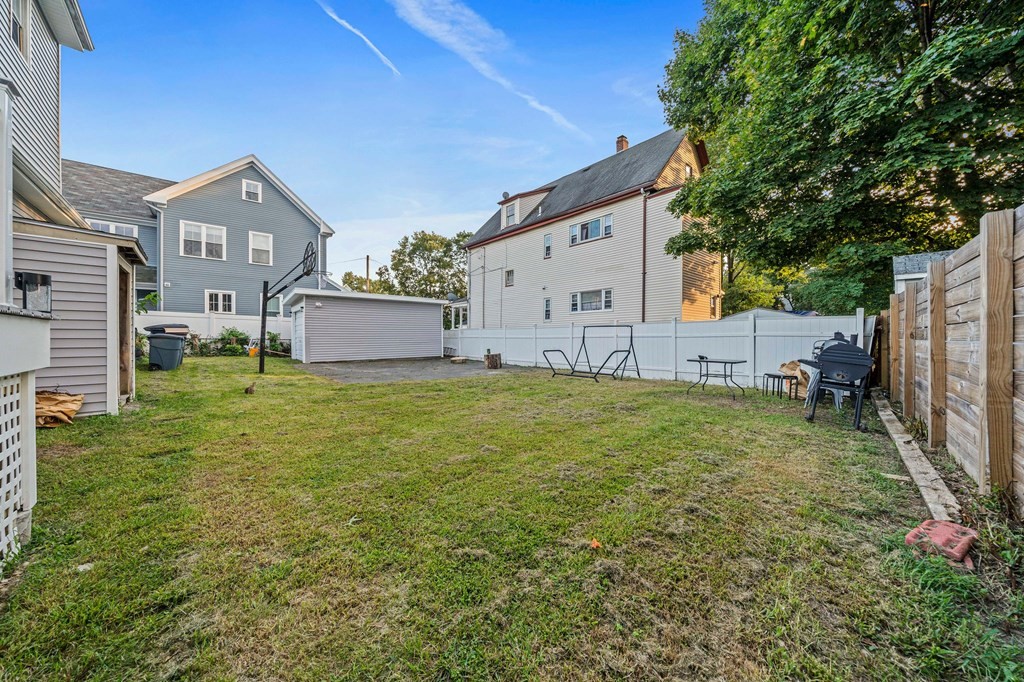 65 Wyvern Street Boston, MA 02131 - Photo 21 of 26 a backyard of a house with table and chairs
