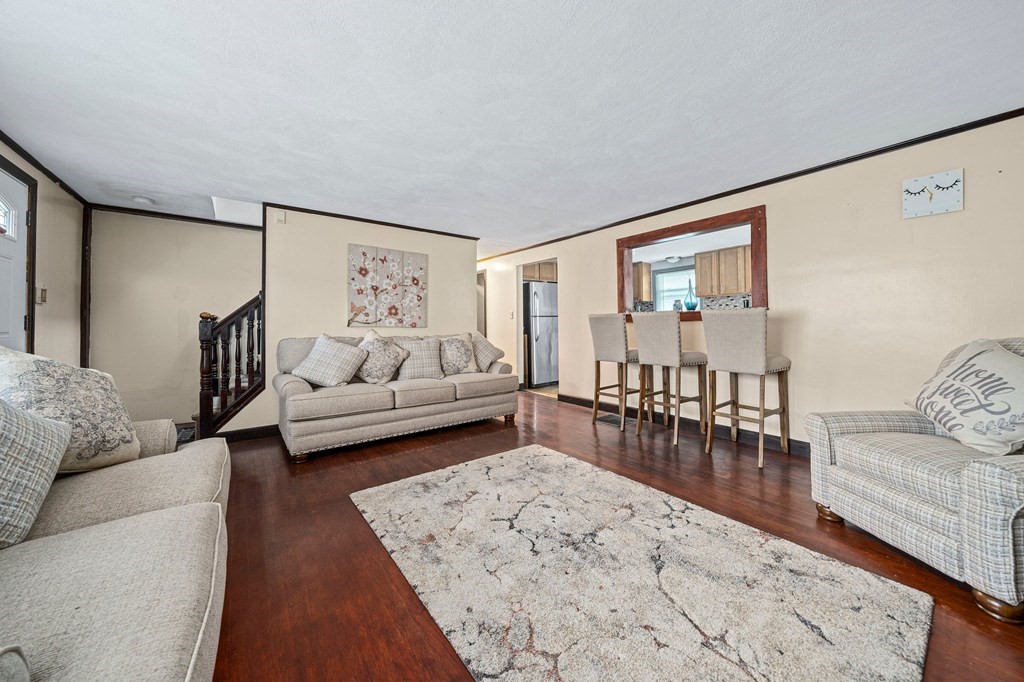 65 Wyvern Street Boston, MA 02131 - Photo 3 of 26 a living room with furniture and wooden floor