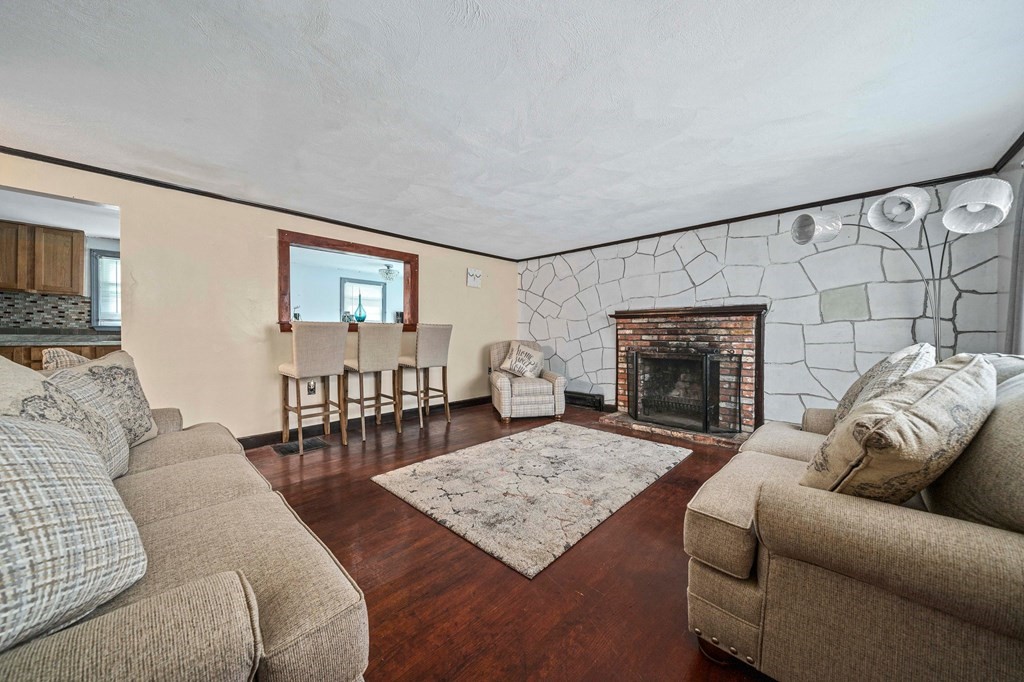 65 Wyvern Street Boston, MA 02131 - Photo 4 of 26 a living room with furniture a fireplace and a table