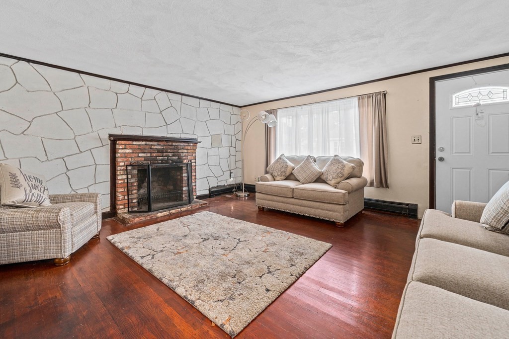 65 Wyvern Street Boston, MA 02131 - Photo 5 of 26 a living room with furniture and a fireplace