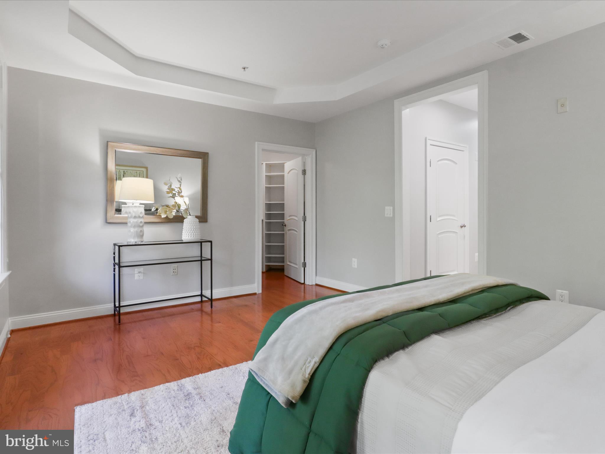 1781 Chain Bridge Road, Unit 303 McLean, VA 22102 - Photo 17 of 56 a bedroom with a bed and a table in it