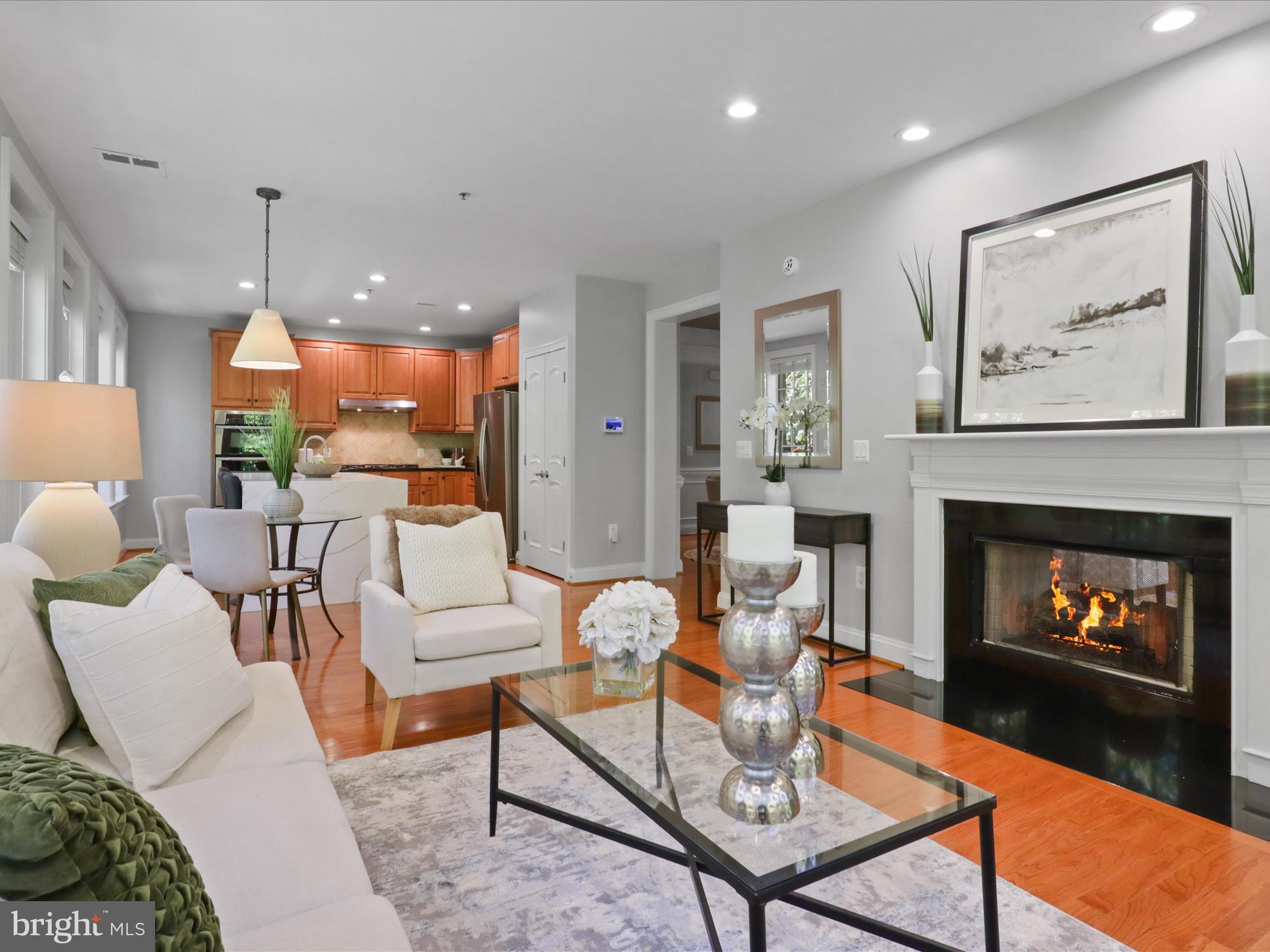 1781 Chain Bridge Road, Unit 303 McLean, VA 22102 - Photo 33 of 56 a living room with furniture a table and a fireplace