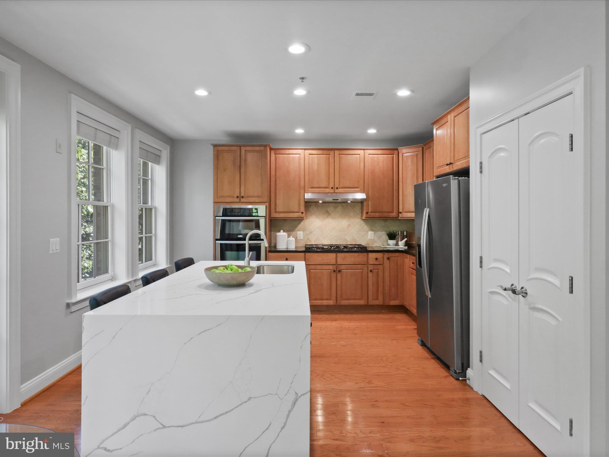 1781 Chain Bridge Road, Unit 303 McLean, VA 22102 - Photo 35 of 56 a kitchen with a refrigerator and a sink