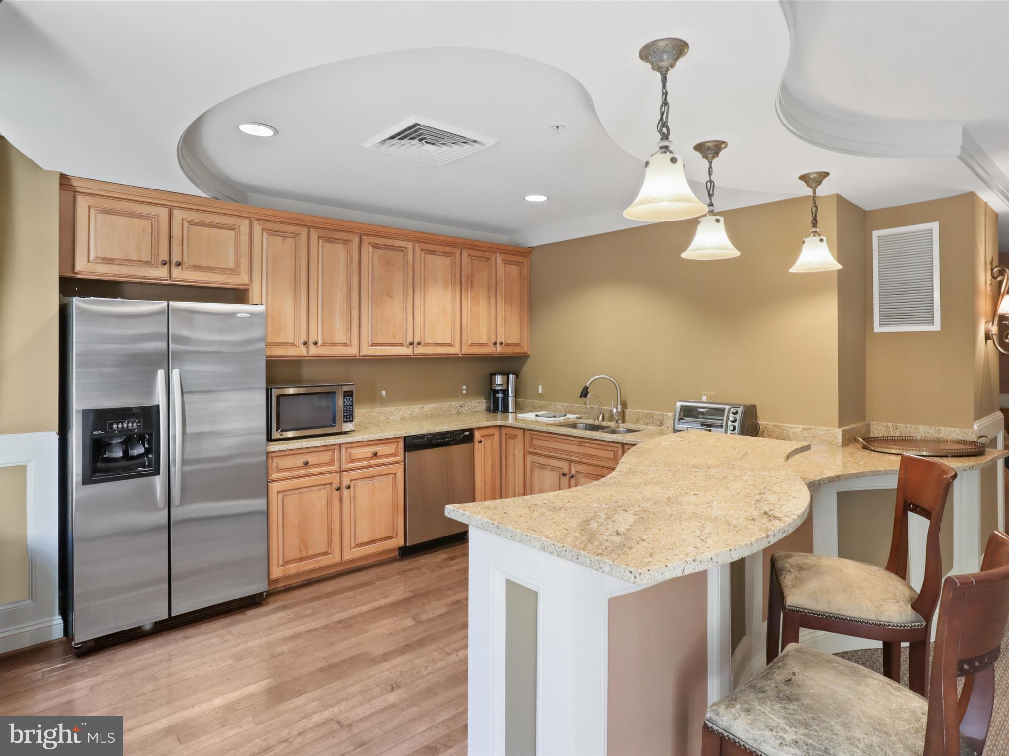 1781 Chain Bridge Road, Unit 303 McLean, VA 22102 - Photo 47 of 56 a kitchen with granite countertop a sink stainless steel appliances and white cabinets