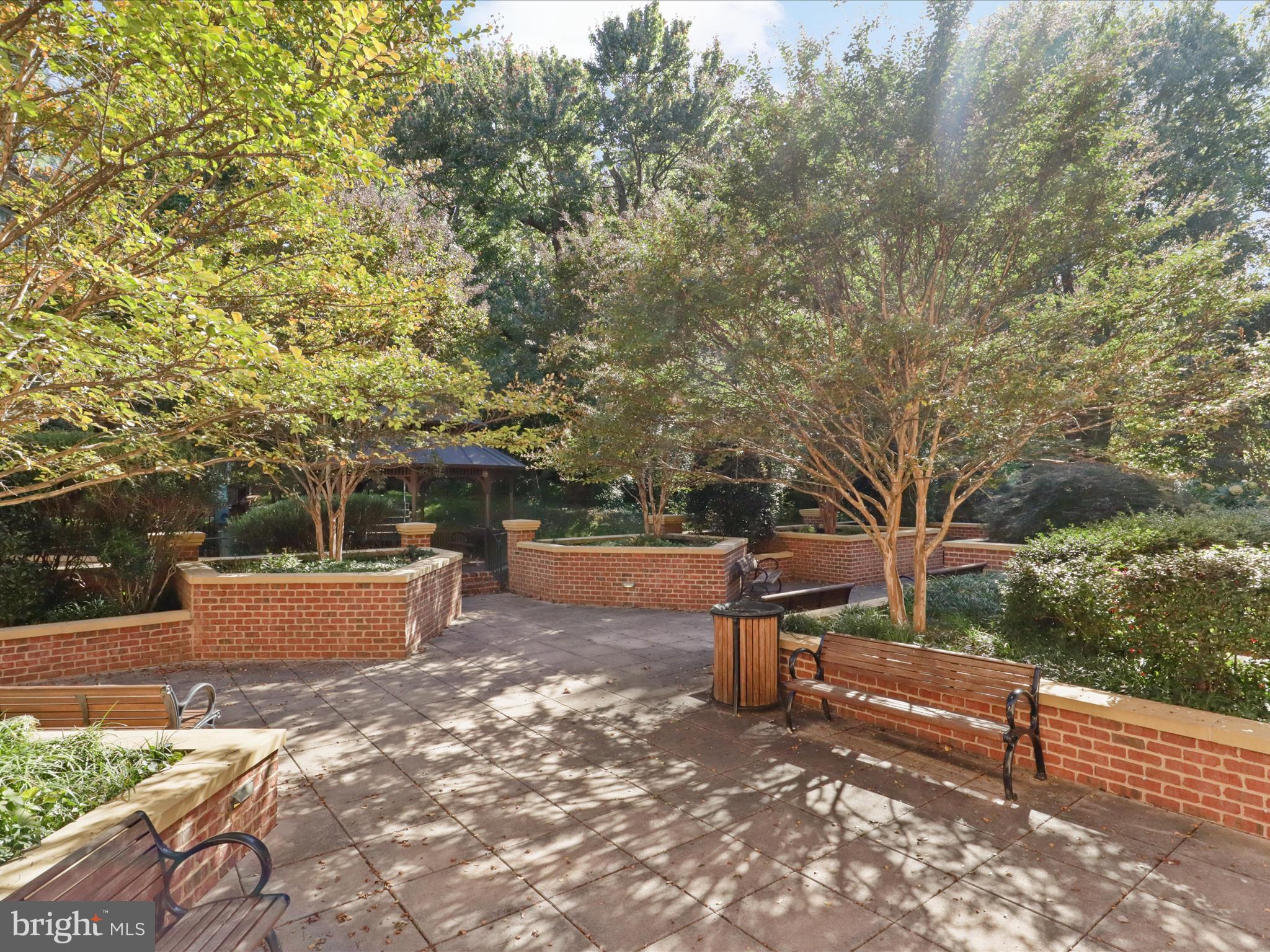 1781 Chain Bridge Road, Unit 303 McLean, VA 22102 - Photo 49 of 56 a backyard of a house with table and chairs