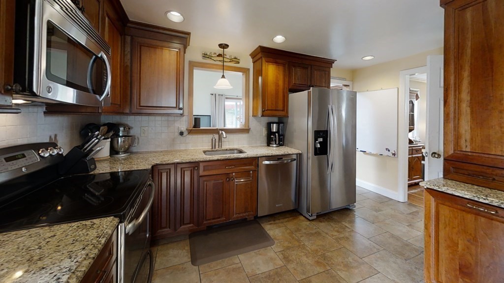 17 Oakcrest Road Needham, MA 02492 - Photo 12 of 31 a kitchen with stainless steel appliances granite countertop a refrigerator and a sink