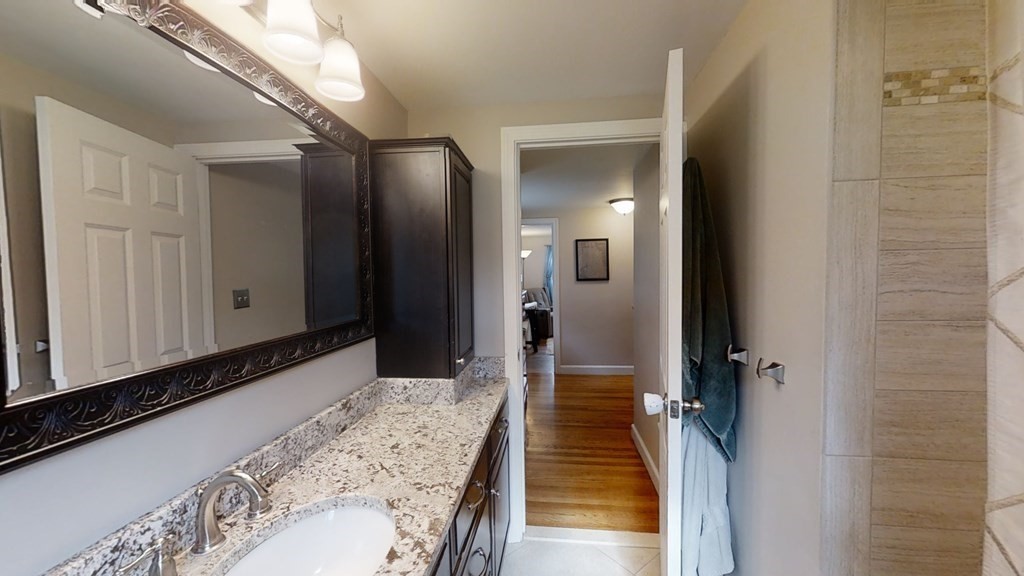 17 Oakcrest Road Needham, MA 02492 - Photo 18 of 31 a bathroom with a sink and a mirror