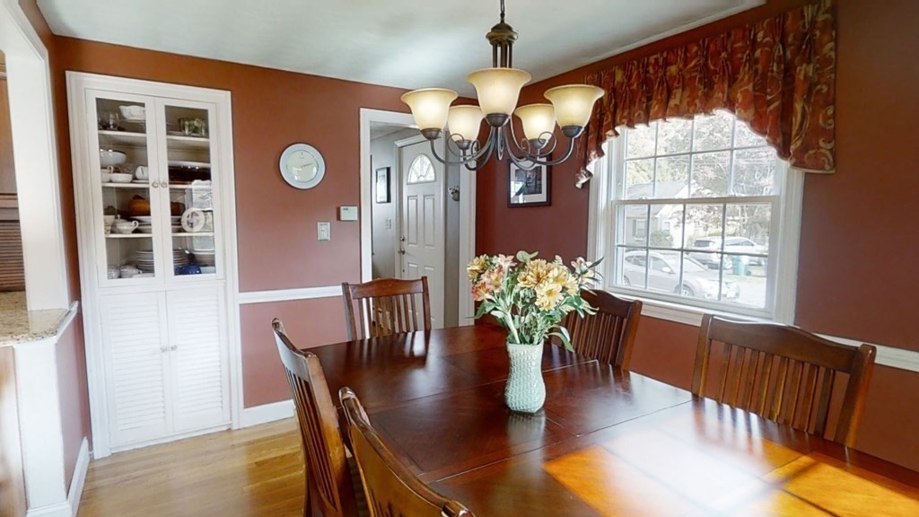 17 Oakcrest Road Needham, MA 02492 - Photo 7 of 31 a dining room with furniture potted plants and wooden floor