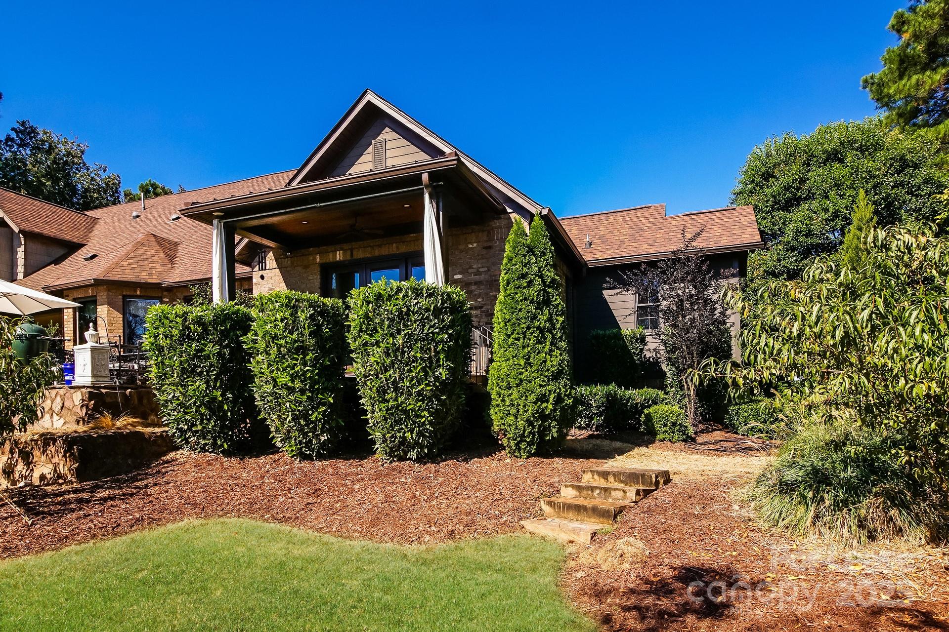 17120 Belle Isle Drive, Unit A Cornelius, NC 28031 - Photo 13 of 16 a front view of a house with a yard