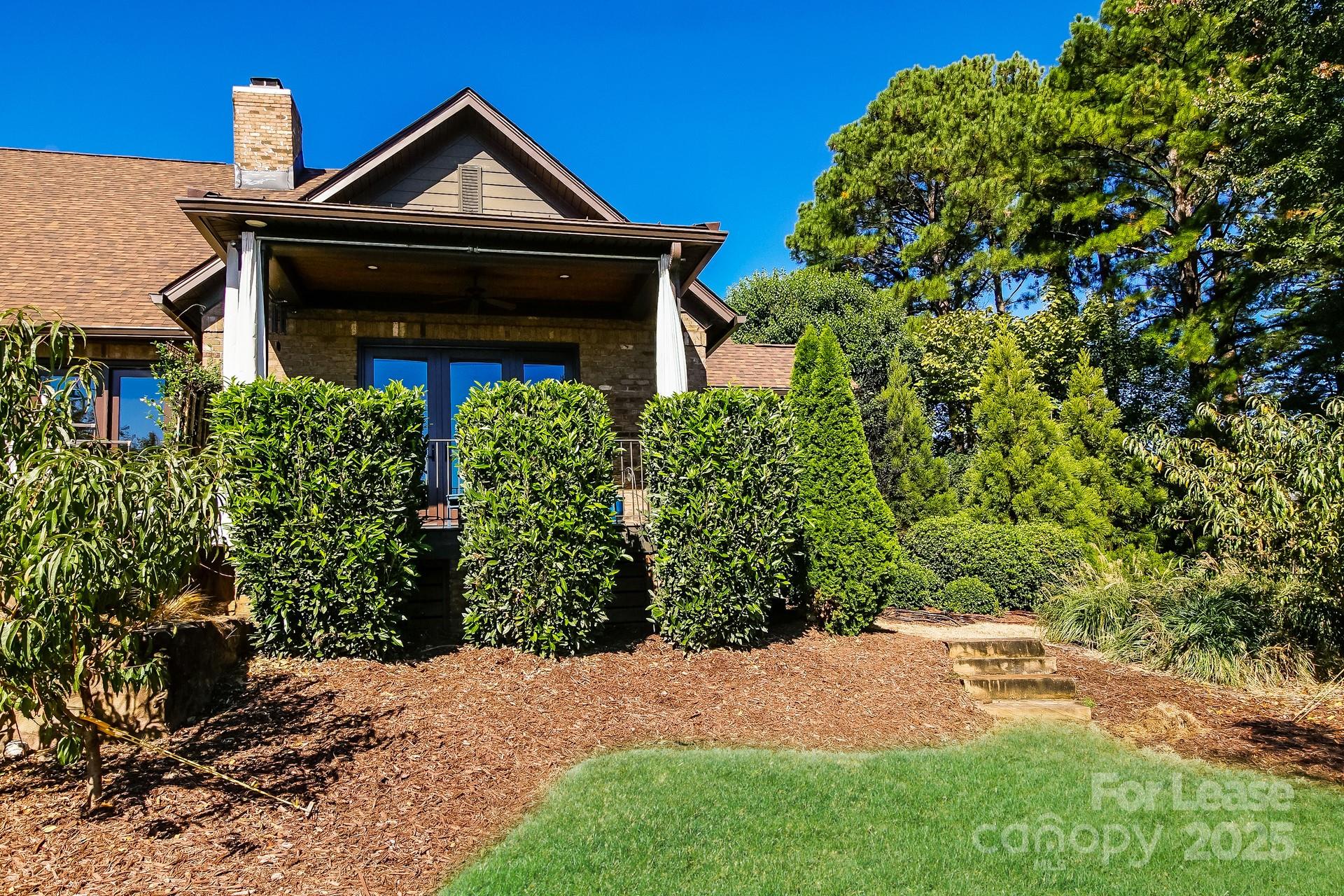17120 Belle Isle Drive, Unit A Cornelius, NC 28031 - Photo 14 of 16 a front view of a house with a yard