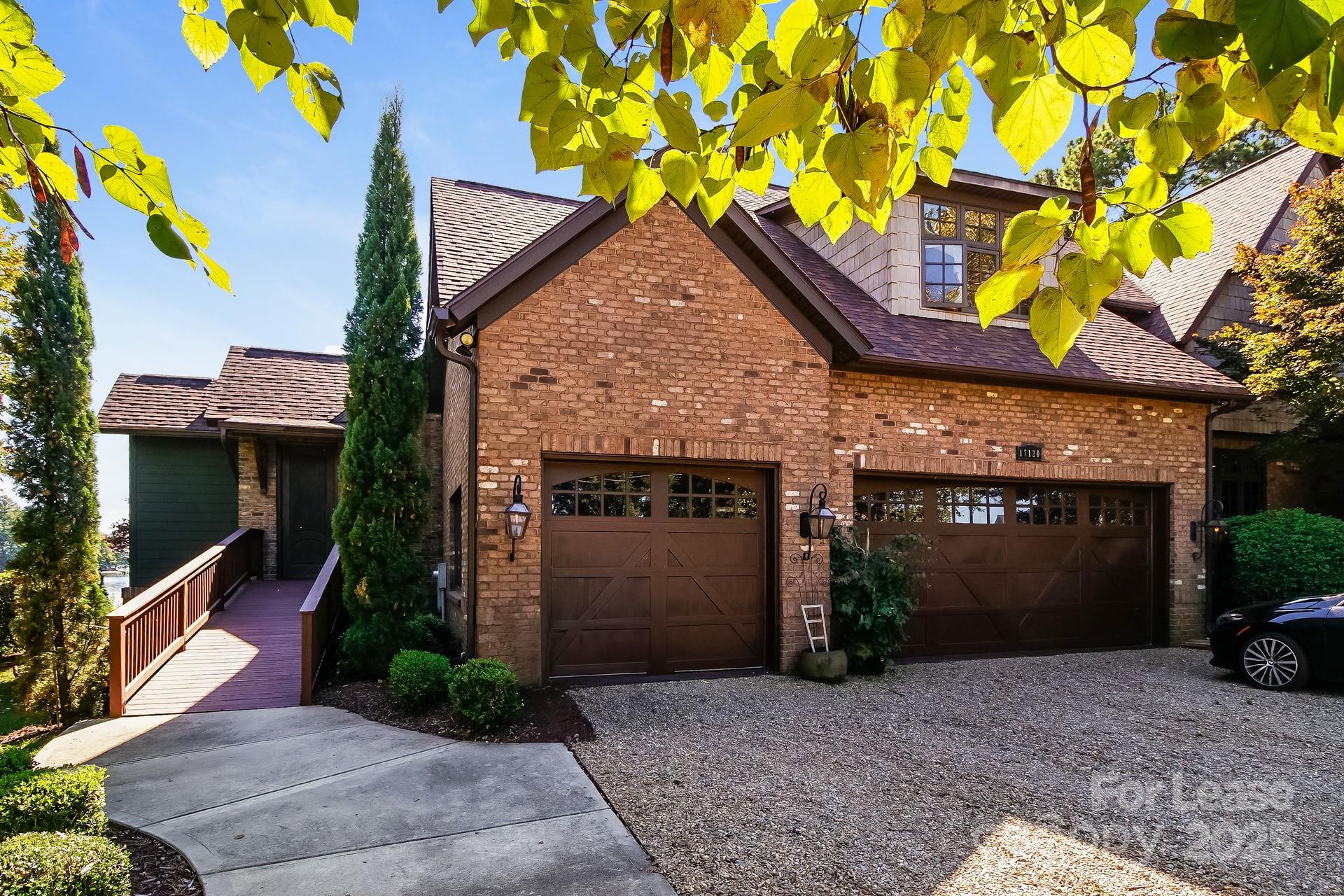 17120 Belle Isle Drive, Unit A Cornelius, NC 28031 - Photo 3 of 16 a front view of a house with a yard and garage