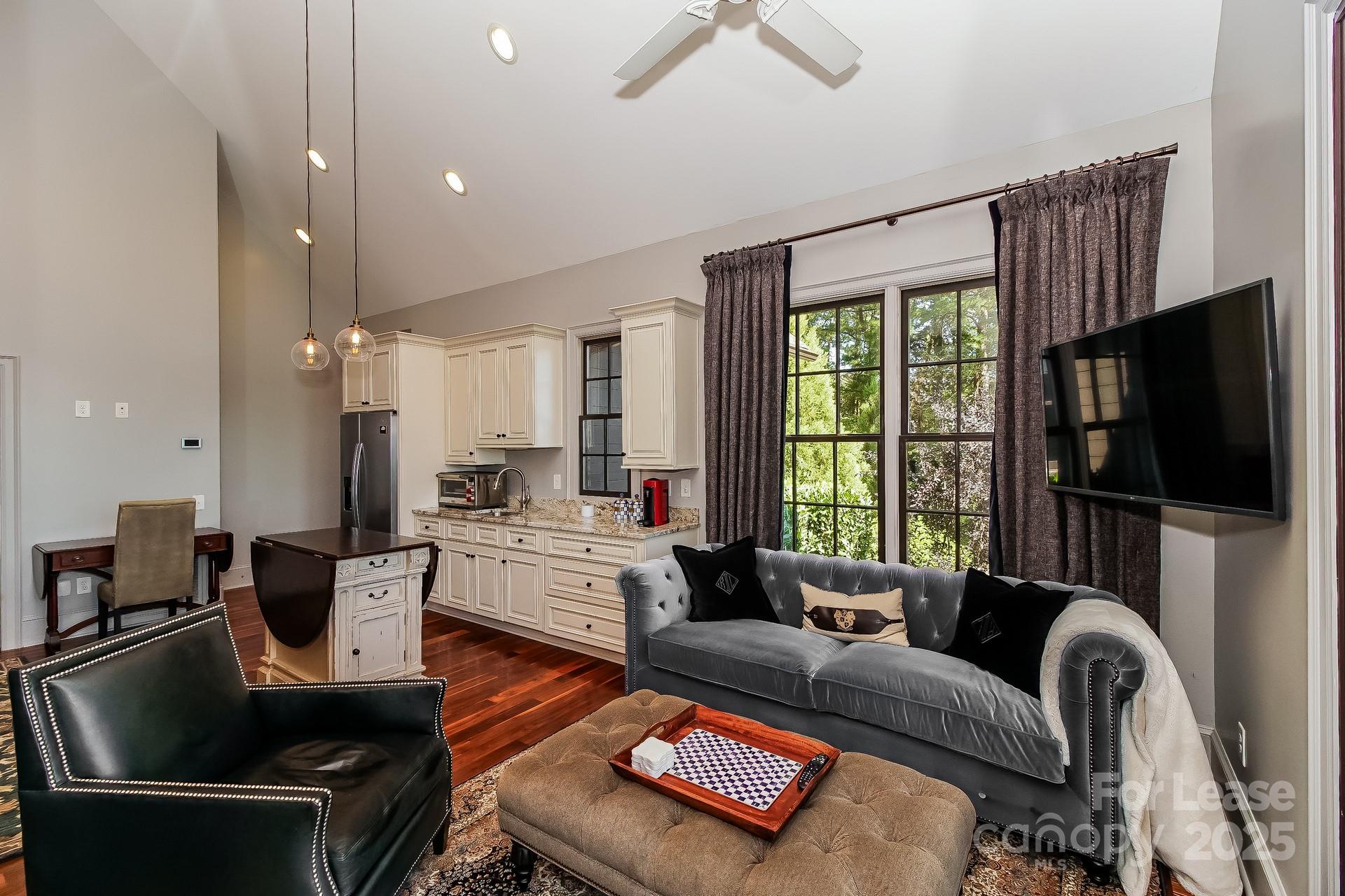 17120 Belle Isle Drive, Unit A Cornelius, NC 28031 - Photo 4 of 16 a living room with furniture fireplace and a flat screen tv