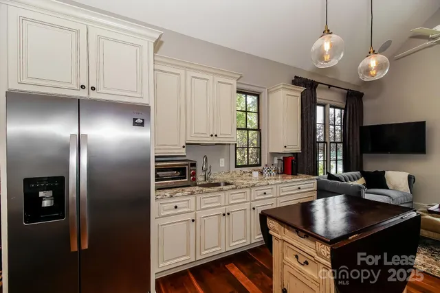 a kitchen with kitchen island granite countertop a sink stainless steel appliances and cabinets