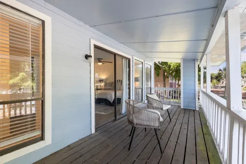 a view of a balcony with wooden floor