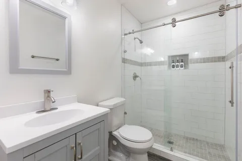 a bathroom with a sink toilet and shower