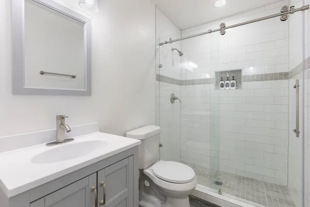 a bathroom with a sink toilet and shower