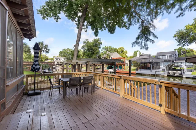 a view of a house with wooden deck and furniture