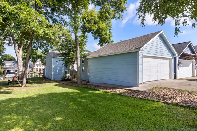 a view of a backyard with a large tree