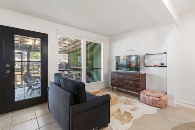 a living room with furniture and a floor to ceiling window