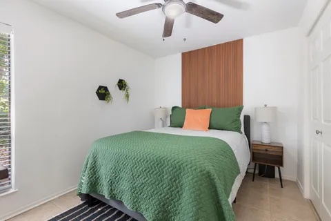 a bedroom with a bed and a window