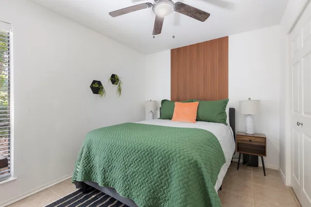 a bedroom with a bed and a window