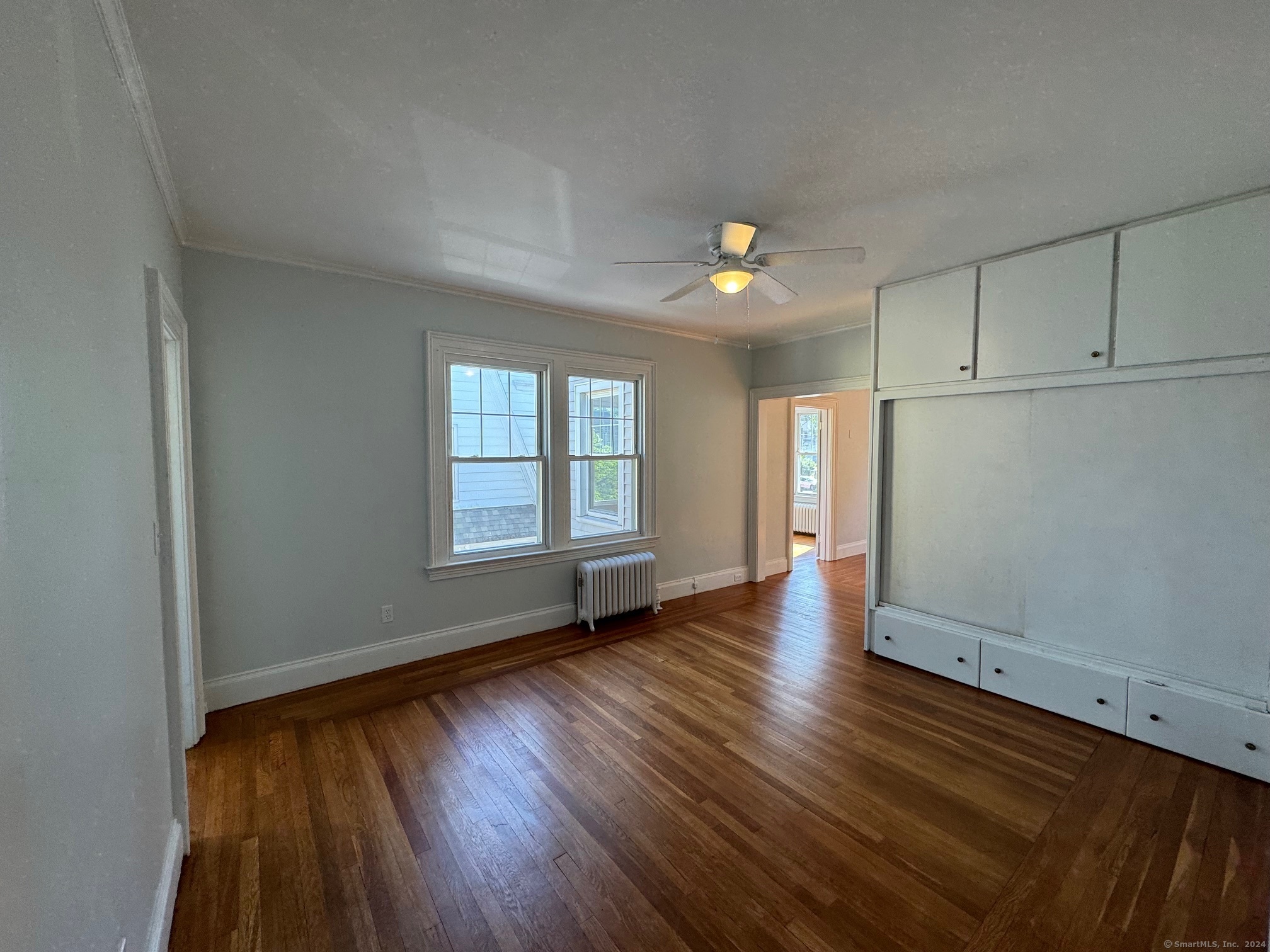 1253 Forest Road, Unit 2 New Haven, CT 06515 - Photo 18 of 30 an empty room with wooden floor and windows