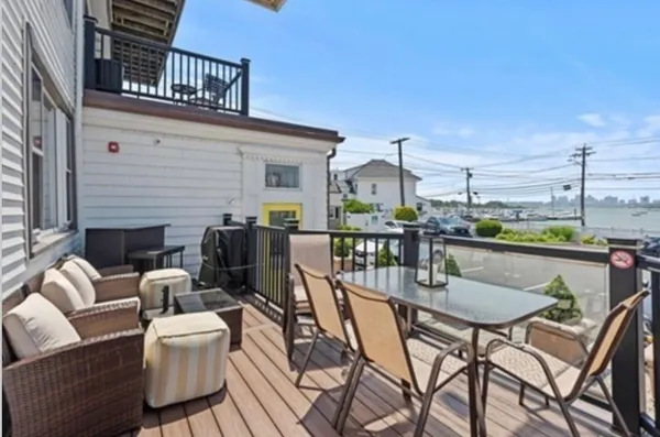 a view of a chairs and tables on the roof deck