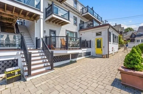 a view of a house with glass windows and furniture